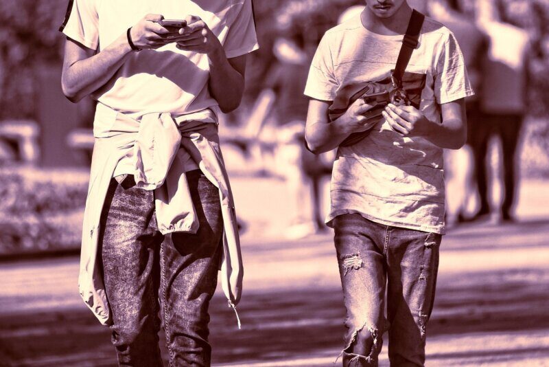 person, man, young man, guy, guys, two, two guys, friends, together, side by side, smartphone, walking, checking phone, outdoors, hand, holding phone, obsession, addicted, sunshine, sunny day, two guys, checking phone, holding phone, holding phone, holding phone, holding phone, obsession, obsession, obsession, obsession, obsession, addicted, addicted